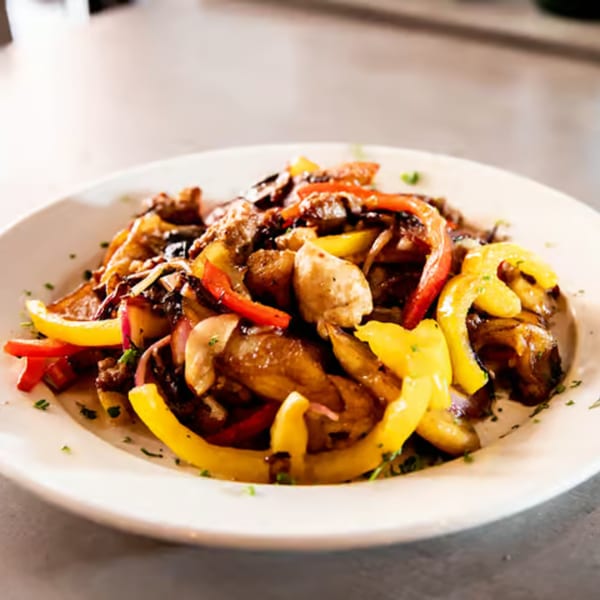 Rocco's Cucina & Bar's Italian dish with chicken, red and yellow bell peppers, and mushrooms.